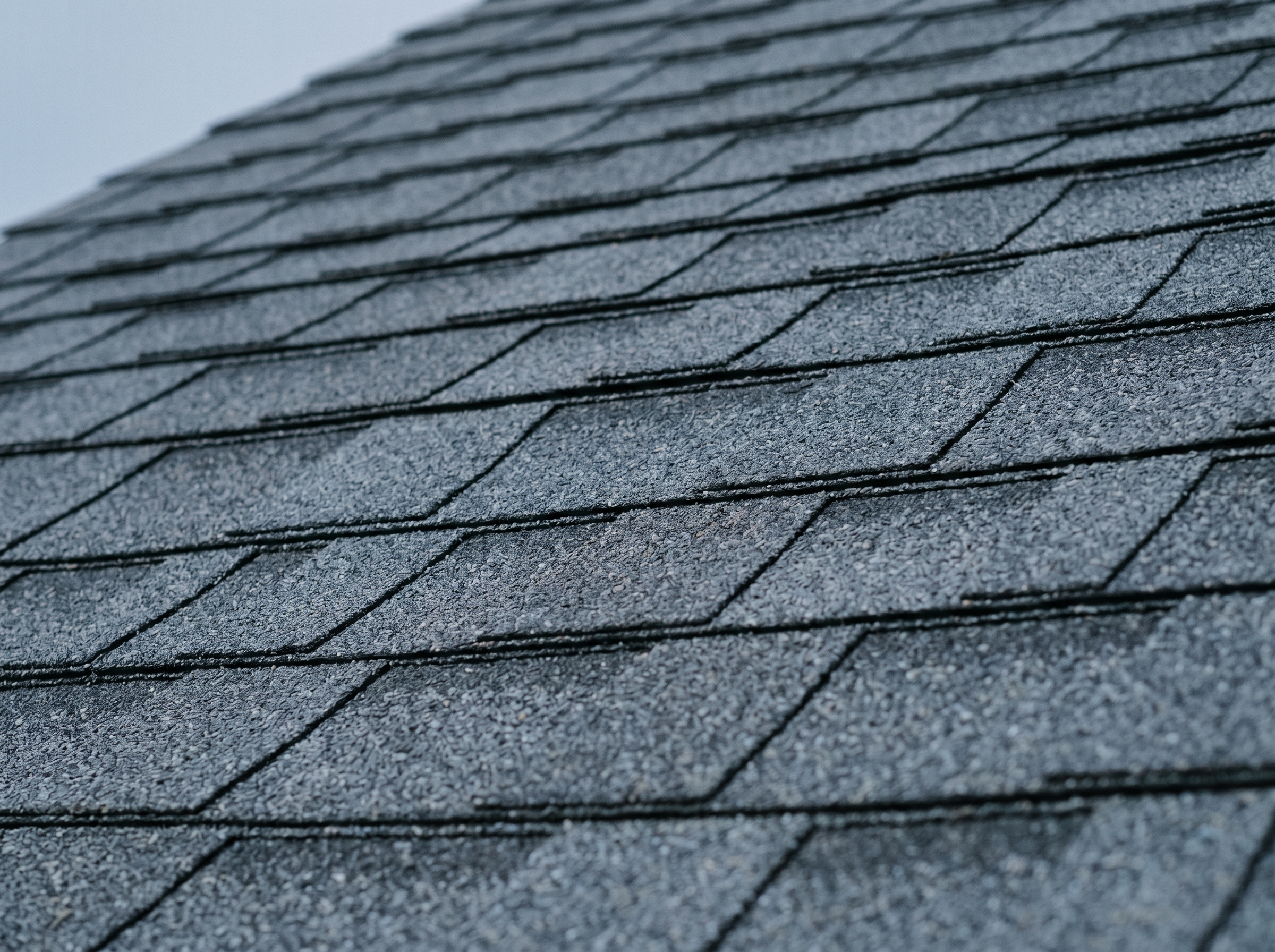 Close-up of freshly installed architectural asphalt shingle courses.